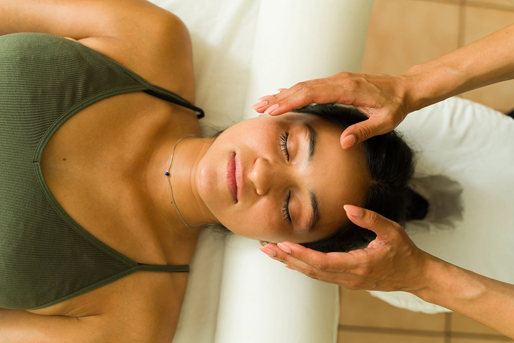 Female patient receiving Reiki treatment